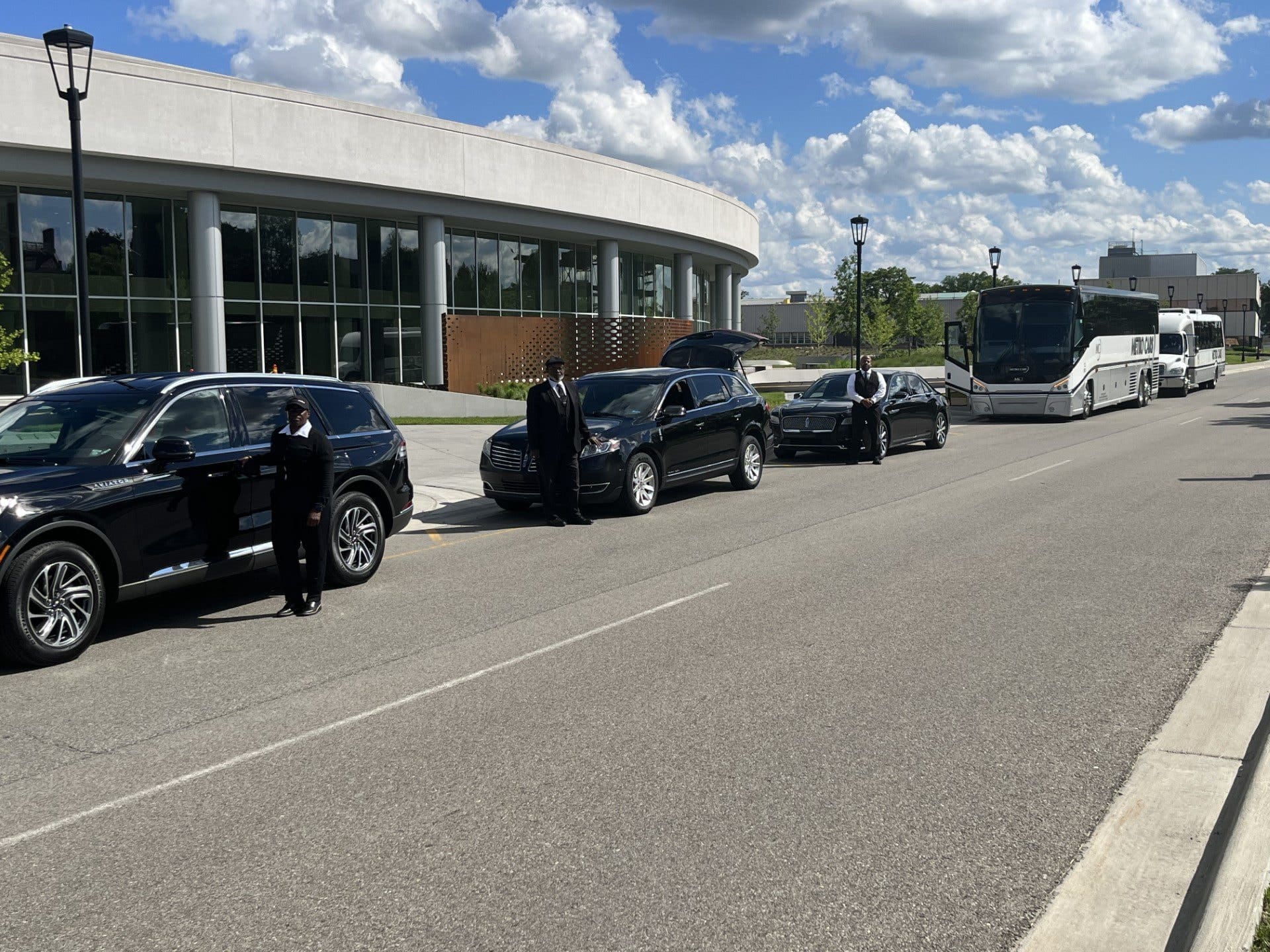 Black cars and buses parked on street